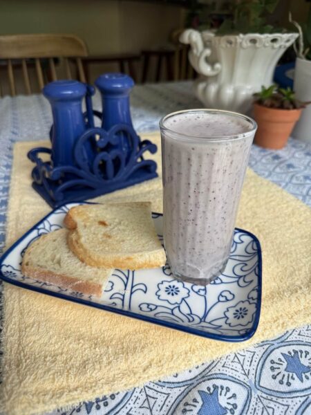 Cucumber Blueberry Basil Refresher Smoothie on a blue and white plate alongside toast